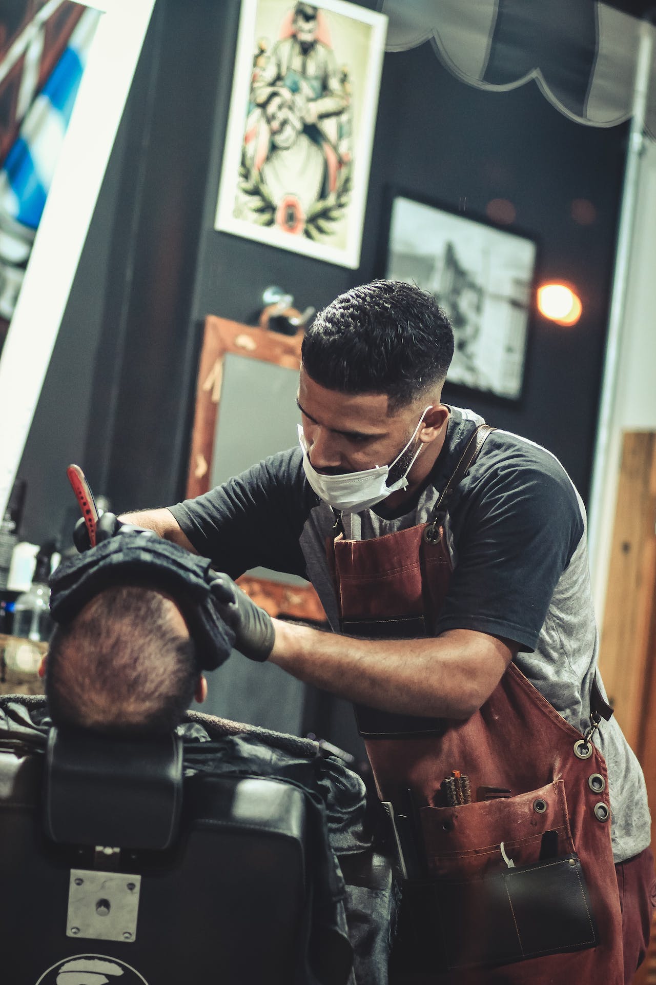 A man getting his hair cut in a barber shop.